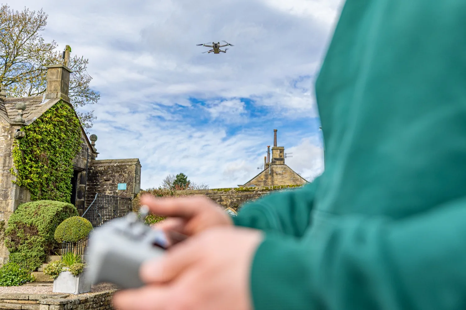 The Halizona drone in the air above an old stone building in Yorkshire